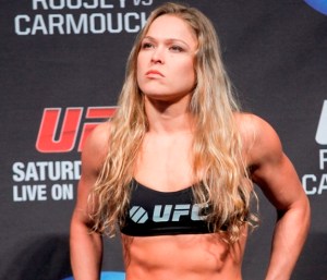 Mixed martial arts fighter UFC bantamweight champion, Ronda Rousey poses during a weight in at the Honda Center in Anaheim, Calif., Friday, Feb. 22, 2013. Rousey will face off Liz Carmouche in the main event at UFC 157 at the Honda Center on Saturday Feb. 23, in the first women's bout in the UFC promotion's history.(AP Photo/Damian Dovarganes) ORG XMIT: CADD109